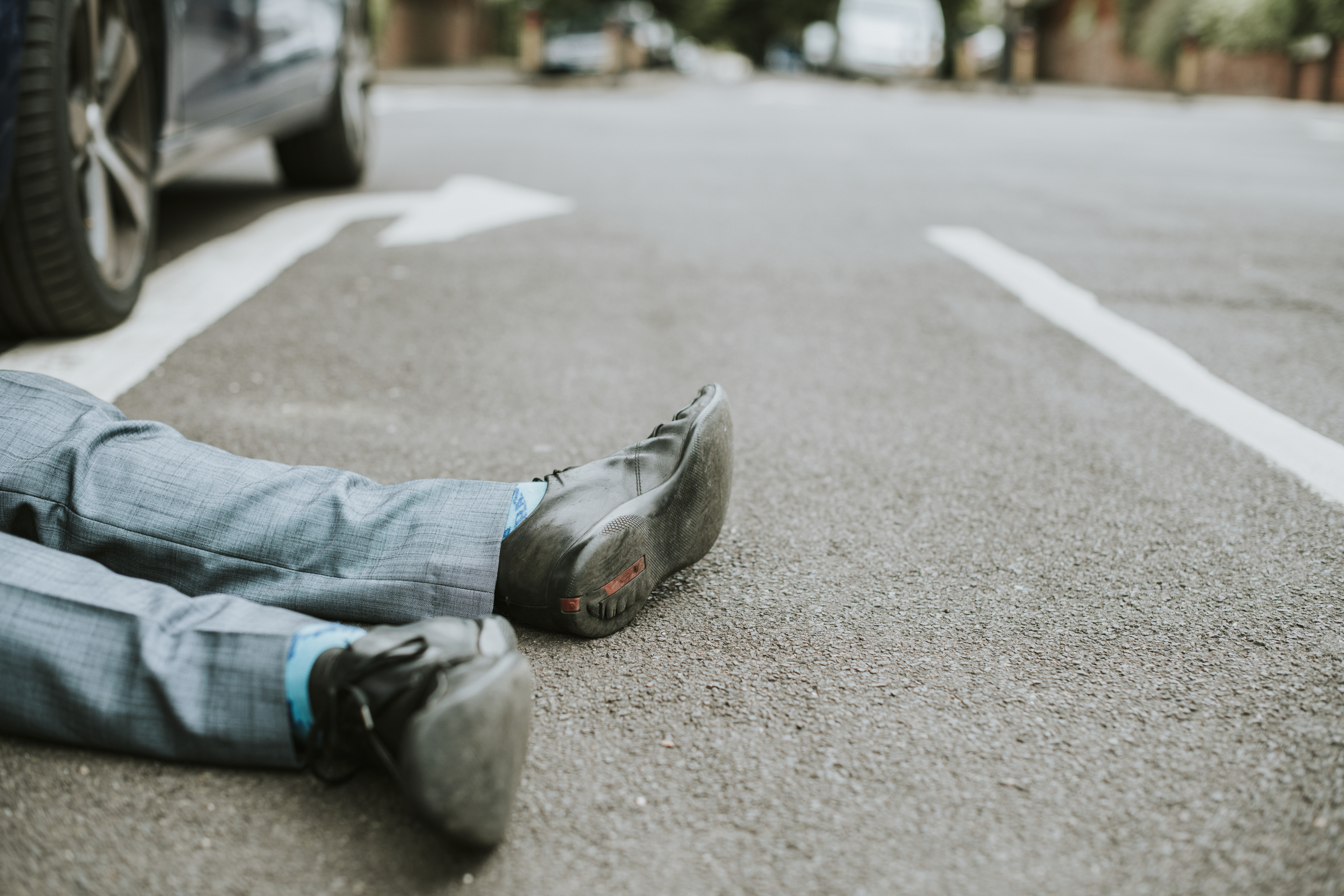 Person lying on the ground after a car accident 911Pedestrian Wrongful Death